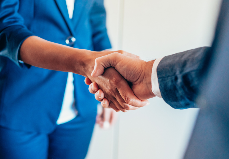 Two individuals shaking hands
