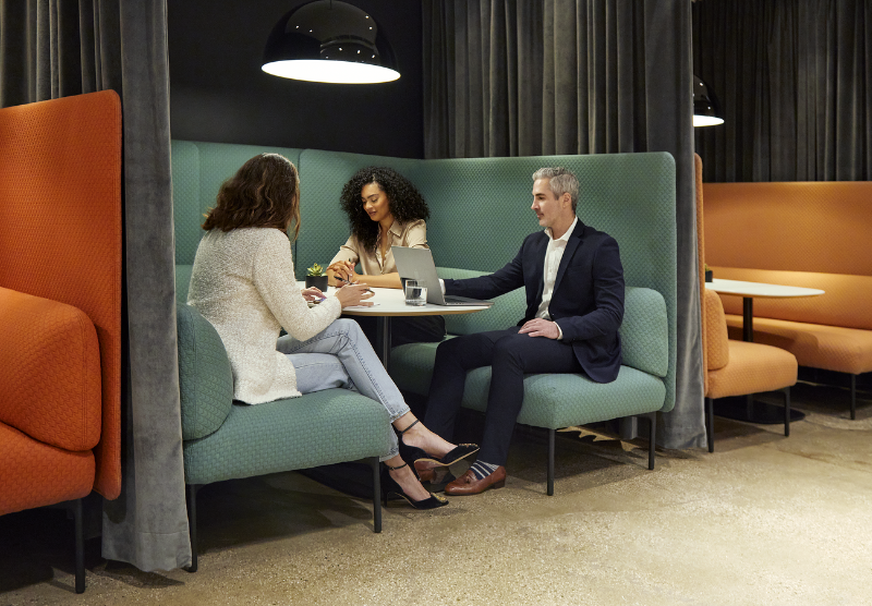 Three coworkers in a booth